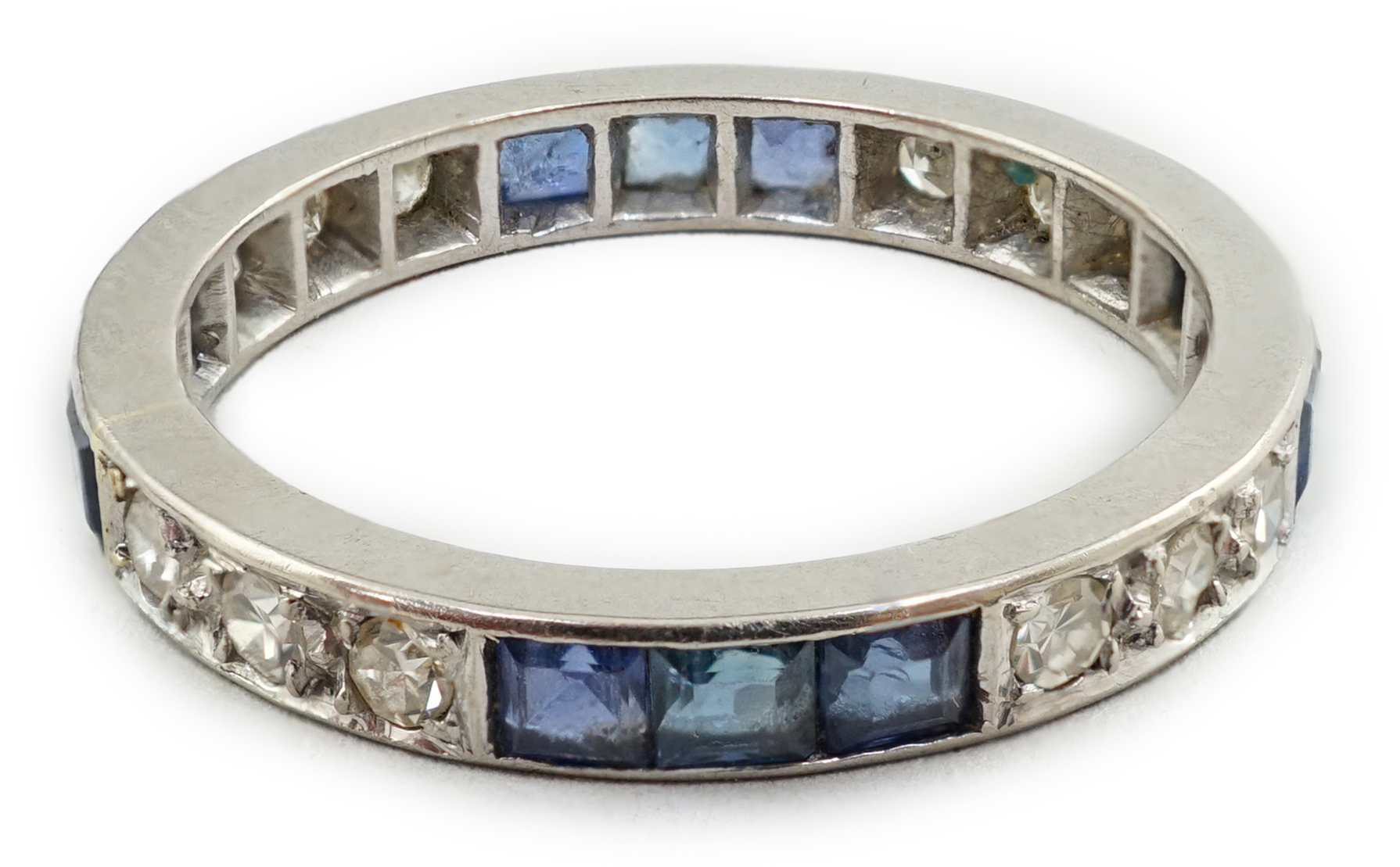 A white gold, twelve stone sapphire and twelve stone diamond set full eternity ring